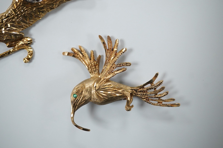 Two 9ct gold brooches, one designed as a collared leopard, its eyes set with rubies, length 5.2cm; the other designed as a hummingbird in flight, its eye set with an emerald, length 4.9cm, each in textured 9ct gold, Brit